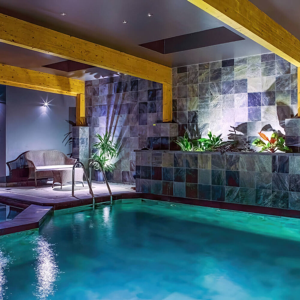 Technician performing pool opening service at a Cleveland residential pool.